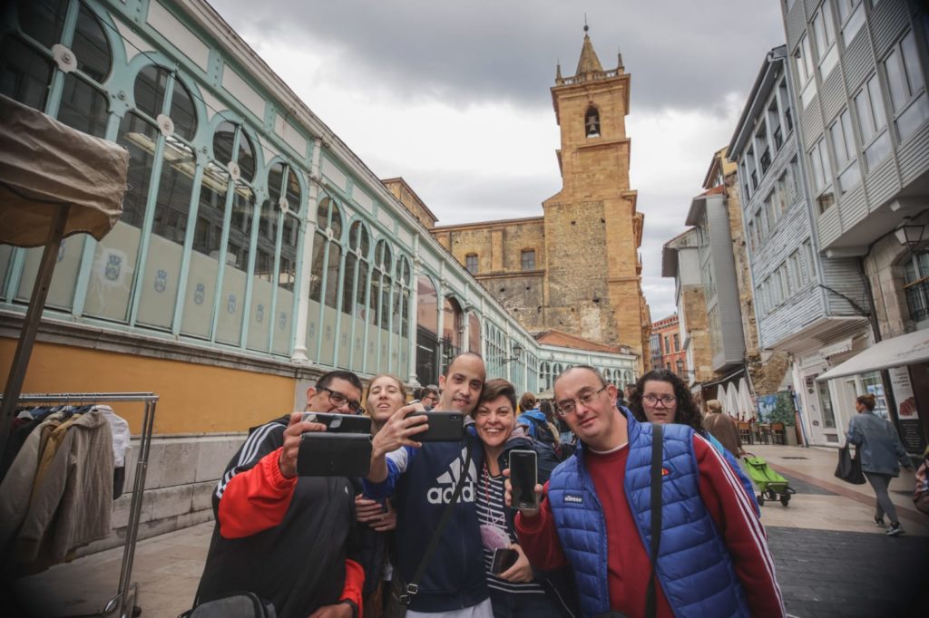 Un grupo de persona se saca selfies en un calle